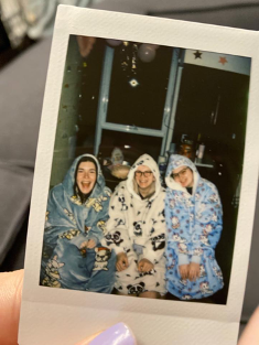 Three friends wearing pajamas in their dorm